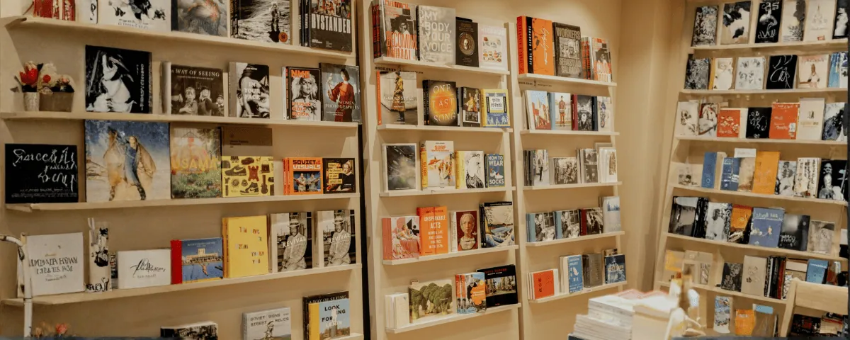 Book covers and papers laid out on a warm orange surface